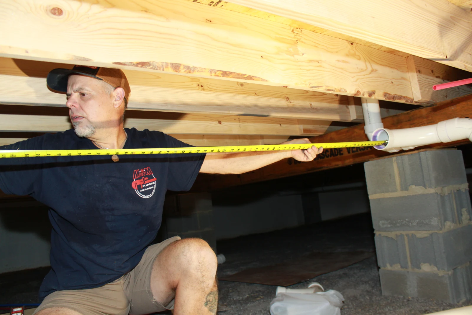 Measuring a drain-pipe run during new-construction rough-in