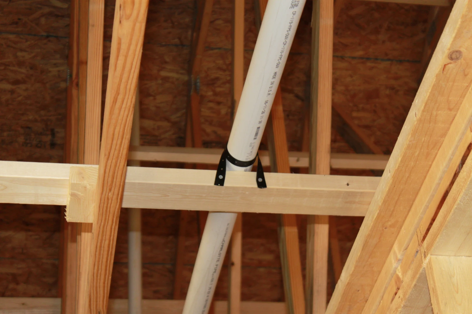 Vent pipe secured to blocking within the roof framing