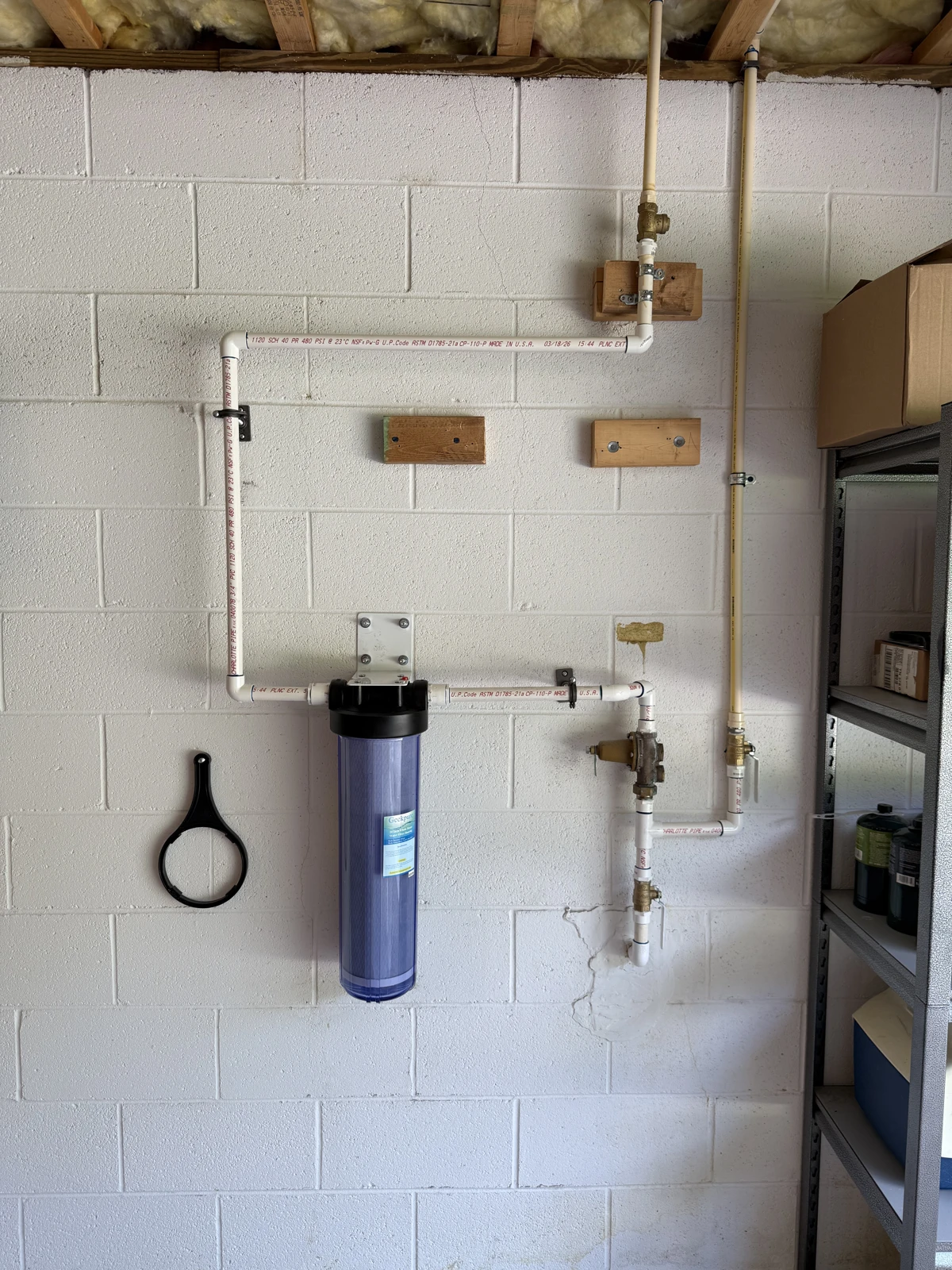 Whole-house water filter with connected supply piping